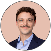 a young man wearing glasses and a hawaiian shirt