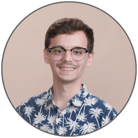 a young man wearing glasses and a hawaiian shirt